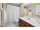 Clean bathroom with a single vanity, large mirror, and shower with white curtain at 6142 Golf View Xing, Locust Grove, GA 30248
