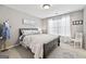 Serene bedroom with soft gray tones, featuring a full-sized bed and bright natural light at 6142 Golf View Xing, Locust Grove, GA 30248