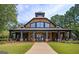 Exterior of community clubhouse with covered porch and manicured lawn at 6142 Golf View Xing, Locust Grove, GA 30248