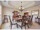 Elegant dining room featuring decorative chandelier, crown molding, and neutral color palette at 6142 Golf View Xing, Locust Grove, GA 30248