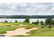 Scenic golf course with sand traps and a view of the lake at 6142 Golf View Xing, Locust Grove, GA 30248