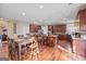 Eat-in kitchen offers hardwood floors, granite countertops, large kitchen island, and plenty of cabinet space at 6142 Golf View Xing, Locust Grove, GA 30248