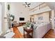Open-concept living room featuring fireplace, hardwood floors, high ceilings and abundant natural light at 6142 Golf View Xing, Locust Grove, GA 30248