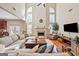 Spacious living room with fireplace, high ceilings, hardwood floors, and abundant natural light at 6142 Golf View Xing, Locust Grove, GA 30248