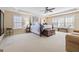 This spacious primary bedroom has great natural light and a trey ceiling with ceiling fan at 6142 Golf View Xing, Locust Grove, GA 30248