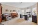 Comfortable home office with plush seating, work desk, natural light and neutral carpeting at 6142 Golf View Xing, Locust Grove, GA 30248