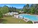 Aerial view of the community pool with a water slide and lounge area at 6142 Golf View Xing, Locust Grove, GA 30248