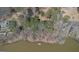 Aerial view showcasing a home with private dock access to a serene lake, surrounded by lush trees and natural beauty at 562 Adams Rd, Fayetteville, GA 30214
