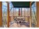 Outdoor deck with canopy featuring dining set and serene wooded views at 562 Adams Rd, Fayetteville, GA 30214