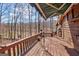 The rustic back deck offers a delightful view of the lake and surrounding trees at 562 Adams Rd, Fayetteville, GA 30214