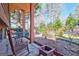 Covered back porch features rocking chairs, a porch swing, and a view of the serene outdoor setting at 562 Adams Rd, Fayetteville, GA 30214