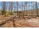 Backyard featuring a wooden pergola, bench swing and wooded backdrop at 562 Adams Rd, Fayetteville, GA 30214