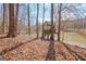 Backyard view featuring a custom treehouse and wooden steps overlooking the lake at 562 Adams Rd, Fayetteville, GA 30214