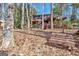 Exterior view of home with multiple decks and stairs, set amongst trees and a bench at 562 Adams Rd, Fayetteville, GA 30214