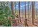 Stairs lead to a backyard with a lake view and a small wooden shed, all surrounded by mature trees at 562 Adams Rd, Fayetteville, GA 30214