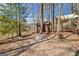 Lakefront backyard with a wooden shed, covered seating area and firepit at 562 Adams Rd, Fayetteville, GA 30214