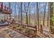 Landscaped backyard with mulch and stone paths, a tiered wooden deck, and scenic lake views at 562 Adams Rd, Fayetteville, GA 30214