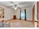 The bright bedroom has neutral walls, a ceiling fan and window overlooking the backyard at 562 Adams Rd, Fayetteville, GA 30214