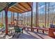 Large wooden deck with seating areas, overlooking a serene lake surrounded by lush trees at 562 Adams Rd, Fayetteville, GA 30214