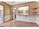 Open dining area featuring hardwood floors, chandelier, with kitchen view through pass-through window at 562 Adams Rd, Fayetteville, GA 30214