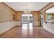 Spacious dining room showcasing hardwood floors, stylish lighting, and views into sunroom and kitchen at 562 Adams Rd, Fayetteville, GA 30214