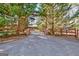 Long driveway leading to home with wooden fence and stone accents at 562 Adams Rd, Fayetteville, GA 30214