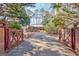 Driveway approach to house surrounded by mature trees and landscaped grounds at 562 Adams Rd, Fayetteville, GA 30214