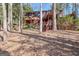 Exterior of a home with multiple decks and stairs, surrounded by tall trees and greenery at 562 Adams Rd, Fayetteville, GA 30214