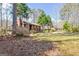 Exterior showcasing large yard with mature trees and wooded setting at 562 Adams Rd, Fayetteville, GA 30214