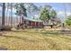 Well-kept home with a green roof surrounded by lush, mature trees at 562 Adams Rd, Fayetteville, GA 30214