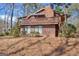 Exterior of home featuring upper and lower decks and natural landscape at 562 Adams Rd, Fayetteville, GA 30214