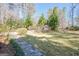Manicured front yard with walkway leading to house and mature landscaping at 562 Adams Rd, Fayetteville, GA 30214