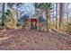 Backyard wooden gazebo with a shingled roof and bench seating at 562 Adams Rd, Fayetteville, GA 30214