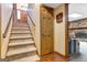 Carpeted staircase leading up to the main door, and brick fireplace in the adjacent room at 562 Adams Rd, Fayetteville, GA 30214