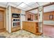Efficient kitchen with stainless steel appliances, built-in microwave and oven, and unique flooring at 562 Adams Rd, Fayetteville, GA 30214