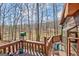 A serene lake view from a spacious wooden deck, surrounded by trees and nature at 562 Adams Rd, Fayetteville, GA 30214