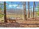 Scenic lakeside view featuring a dock and lounge chairs at 562 Adams Rd, Fayetteville, GA 30214