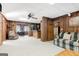 A spacious living room features wood paneling, a plush sofa, and an inviting open floor plan at 562 Adams Rd, Fayetteville, GA 30214