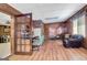 Brightly lit living room with wood-paneled walls, tile ceiling, and adjacent office space at 562 Adams Rd, Fayetteville, GA 30214