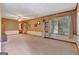 Bright living room with textured walls, natural light, and access to bathroom and exterior at 562 Adams Rd, Fayetteville, GA 30214