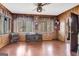 Living room featuring wood paneling, a ceiling fan, and bright windows for natural light at 562 Adams Rd, Fayetteville, GA 30214