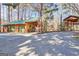 A two-car outbuilding/garage sits next to an open shed under mature trees and a large concrete parking pad at 562 Adams Rd, Fayetteville, GA 30214