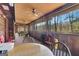 Enclosed wood porch with view of wooded area, ceiling fans and natural light at 562 Adams Rd, Fayetteville, GA 30214