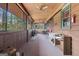 Enclosed wood porch with view of wooded area, ceiling fans and natural light at 562 Adams Rd, Fayetteville, GA 30214