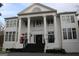 Majestic white brick home with grand columns and elegant architectural details for timeless appeal at 337 Lakeshore Dr, Berkeley Lake, GA 30096