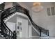 Stunning foyer with a sweeping staircase, intricate iron railings and dazzling chandelier at 337 Lakeshore Dr, Berkeley Lake, GA 30096