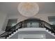 Elegant foyer showcasing a crystal chandelier and graceful staircase at 337 Lakeshore Dr, Berkeley Lake, GA 30096