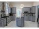 Spacious kitchen with stainless steel appliances, large island, marble floors, and bright lighting at 337 Lakeshore Dr, Berkeley Lake, GA 30096