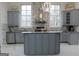 Bright, gray kitchen with stainless steel appliances, island, and marble countertops at 337 Lakeshore Dr, Berkeley Lake, GA 30096