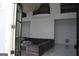Open-concept living room with grand chandelier, high ceilings, and oversized sofa at 337 Lakeshore Dr, Berkeley Lake, GA 30096
